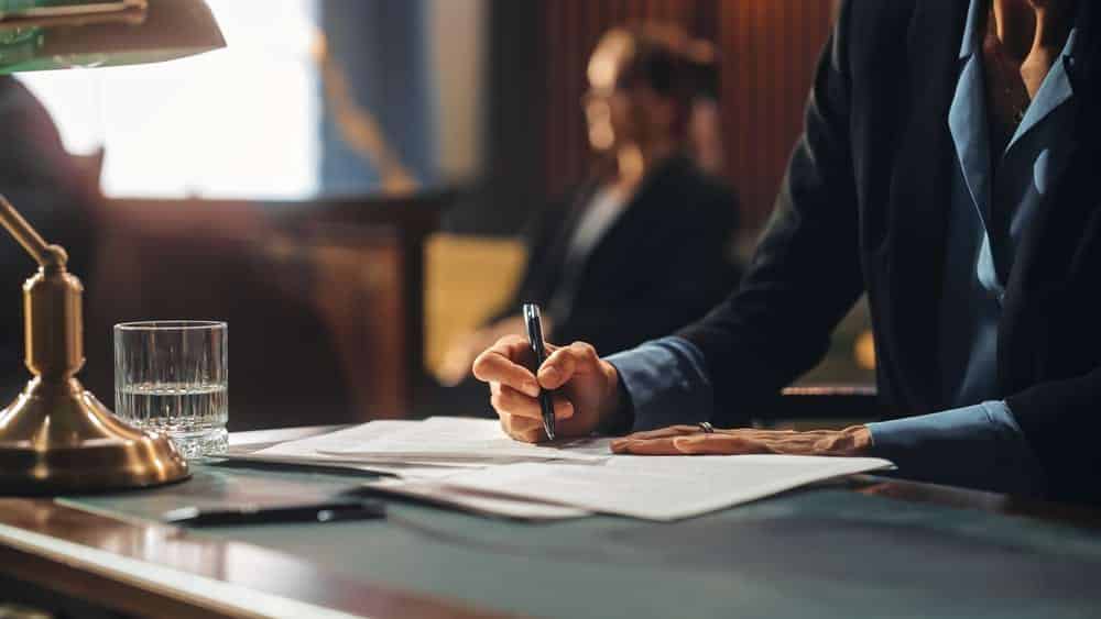 person working at a desk with a pen