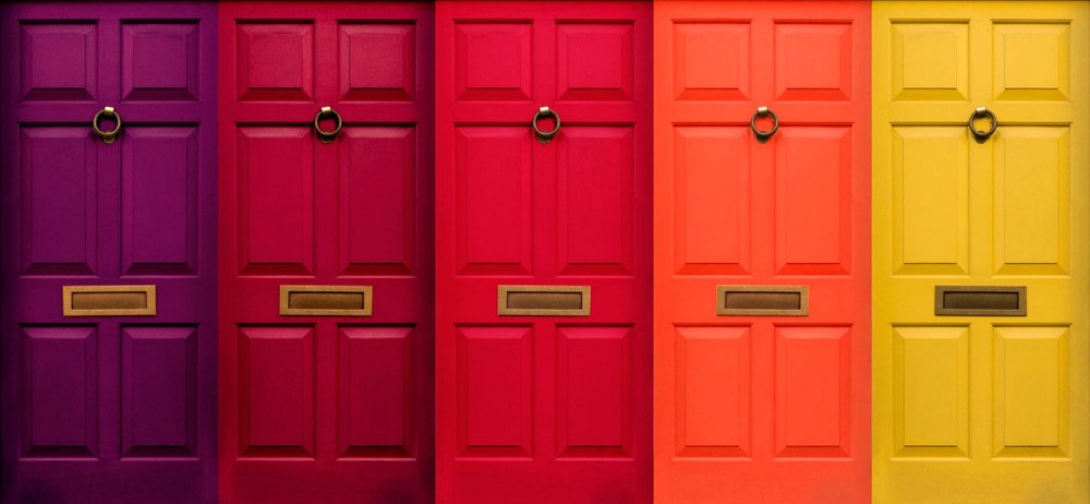 five front doors side by side painted from dark purple to yellow